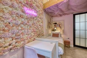 a room with a wall covered in flowers at Eclectic Maisonette in Luqa in Luqa +54 photos
