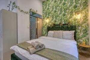 a bedroom with a large bed with towels on it at Eclectic Maisonette in Luqa in Luqa