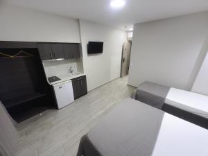 a small room with a kitchen and a bed and a table at Casa Di Mare II in Olympic Beach