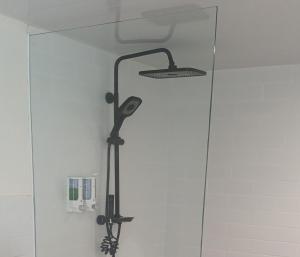 a shower head in the corner of a bathroom at Cozzy Bitu Garden in Bunder