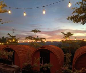 a group of domes in a garden at sunset at Cozzy Bitu Garden in Bunder