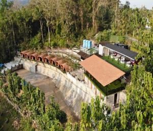 an aerial view of a house in a forest at Cozzy Bitu Garden in Bunder