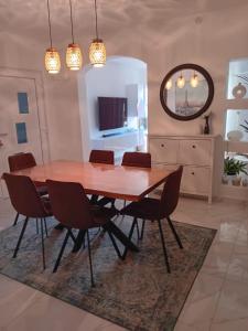 a dining room with a wooden table and chairs at Hanna in Dramalj