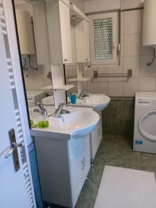 a bathroom with two sinks and a toilet at Hanna in Dramalj +22 photos