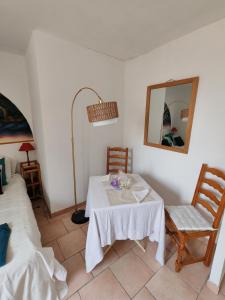 a room with a table and two chairs and a mirror at Etage privatif au calme - 2 chambres & salle de bains in Barret-de-Lioure