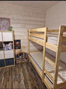 a bedroom with two bunk beds and a book shelf at Propriété avec piscine in Vensac