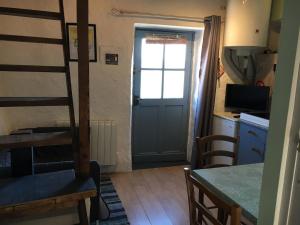 a room with a door and a table and a desk at Tour médiévale in Saint-Georges-de-Luzençon