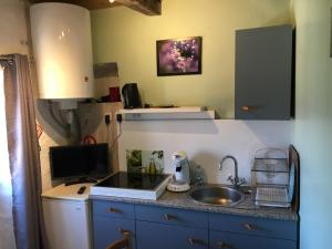 a kitchen with a sink and a counter top at Tour médiévale in Saint-Georges-de-Luzençon +7 photos