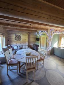 a room with a table and chairs and a couch at Sodyba Atgaiva in Lazdininkai