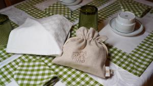 a table with a green and white table cloth with a purse at Vila Dias in Mértola +8 photos