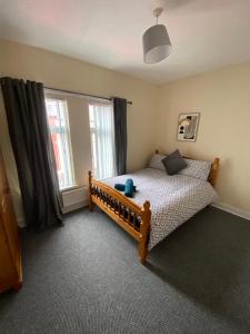 a bedroom with a bed and a large window at spamount house in Belfast
