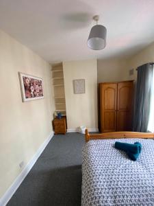 a bedroom with a bed with a blue object on it at spamount house in Belfast