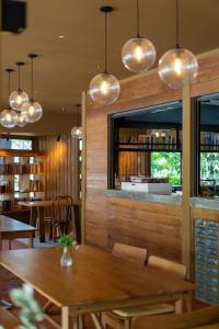 a dining room with a table and chairs and lights at Na Sook Wellness Resort in Ao Nam Mao
