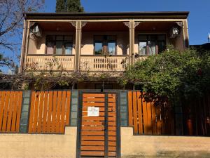 a house with wooden doors and a fence at Hotel "Tbilisi Tales" in the heart of the Old City in Tbilisi City