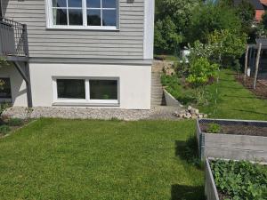 a backyard of a house with a garden at Utting Schulstrasse in Utting am Ammersee