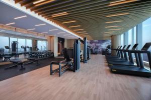 a gym with treadmills and exercise equipment in a building at Huzhou Marriott Hotel Nanxun in Huzhou