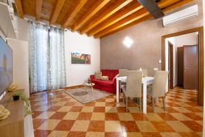 a living room with a table and a red couch at Mazzini Luxury Suite in Verona