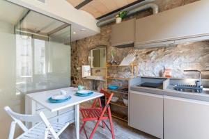 a kitchen with red chairs and a white table at Aromatik apartments in Girona +213 photos