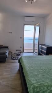 a bedroom with a bed and a view of the ocean at A-mare Casa vacanza in Gagliano del Capo