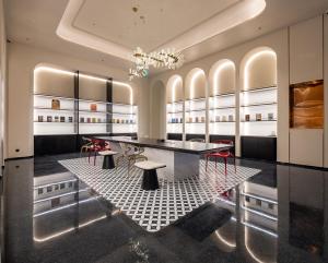 a dressing room with a table and stools at Dream Palace Ben Thanh Grand Hotel in Ho Chi Minh City