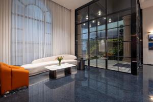a living room with a couch and a table at Dream Palace Ben Thanh Grand Hotel in Ho Chi Minh City