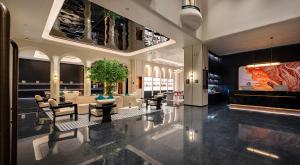 a lobby of a hotel with chairs and tables at Dream Palace Ben Thanh Grand Hotel in Ho Chi Minh City