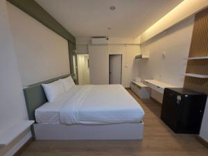 a bedroom with a large white bed in a room at PKK hotel Residence in Bang Phli