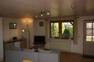 a living room with a couch and a window at Boddenbrise in Born