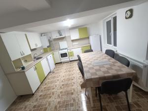 a kitchen with a table and chairs in a room at Casa Ramona in Turda