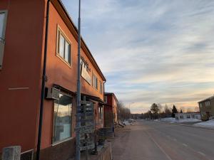 an orange building on the side of a street at Härjulfs hus in Lillhärdal