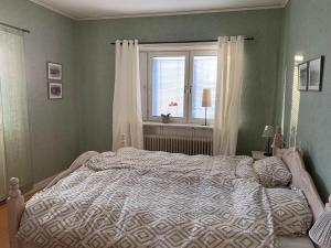 a bedroom with a large bed and a window at Härjulfs hus in Lillhärdal