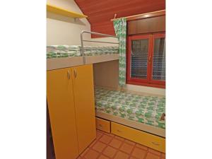 a room with two bunk beds and a window at Sotto il Pino 14 in Eraclea Mare