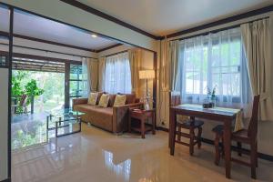 a living room with a couch and a table at Bang Po Hut in Ban Bang Po +37 photos