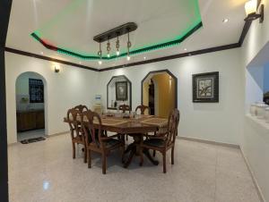 a dining room with a wooden table and chairs at Arangala View in Elhanyaya +24 photos