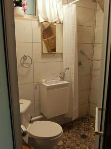 a bathroom with a toilet and a sink at Calamari Suite in Acre +28 photos