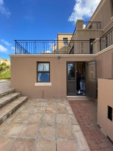 a man standing in the doorway of a house at 22 on Shiraz 2 in Bellville
