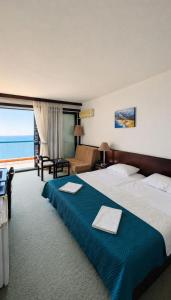 a hotel room with a large bed and a large window at CORPUS A - Hotel Albatros in Ulcinj