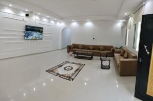 a living room with couches and a rug at شالية الكناري in Taif