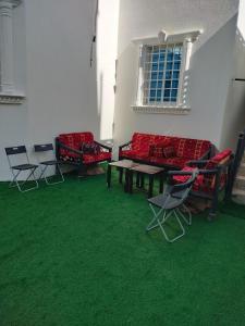 a room with couches and a table and chairs at شالية الكناري in Taif