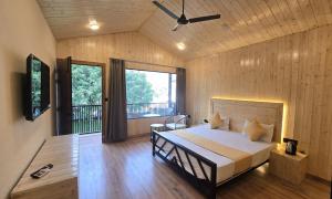 a bedroom with a bed in a room with wooden walls at Aqua Forest River Resort in Bijni