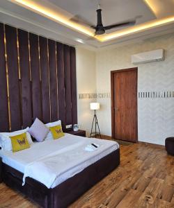 a bedroom with a large bed and a wooden floor at Lux Bliss Bed & Breakfast in Amritsar
