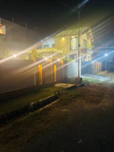 a building with lights on the side of it at night at Lux Bliss Bed & Breakfast in Amritsar