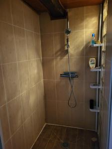 a bathroom with a shower with a shower head at Anaky rider nomade in Curvalle