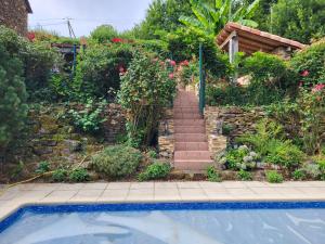 a garden with a stairs and a swimming pool at Anaky rider nomade in Curvalle +10 photos