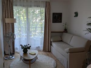 a living room with a couch and a table at Le Jourdain in Paris +22 photos