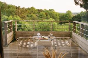 two chairs and a table on a wooden deck at Carrière Sauvage in Pont-Aven