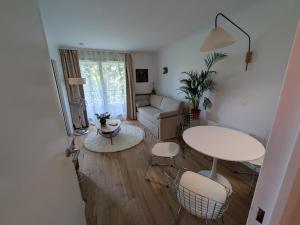 a living room with a couch and a table and chairs at Le Jourdain in Paris
