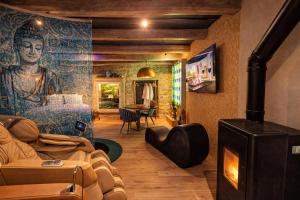 a living room with a painting on the wall at Les suites du Bouddha Bleu in Carnac