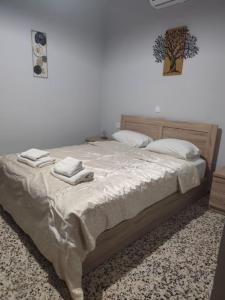 a bedroom with a bed with two towels on it at Garden studio N4 in Archangelos