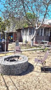 two chairs and a fire pit in a yard at Таки Дача на Фонтане in Odesa